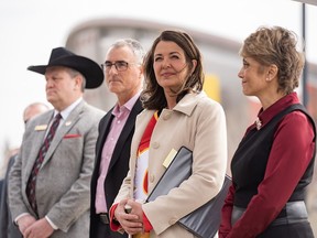 Joel Cowley, CEO of the Calgary Stampede, left, John Bean, president and CEO of CSEC, Premier Danielle Smith and Mayor Jyoti Gondek at Tuesday's announcement about a new Flames arena.
