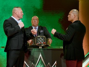 LAS VEGAS, NEVADA - OCTOBER 11: WWE champion Brock Lesnar (L) and former UFC heavyweight champion Cain Velasquez face off as Lesnar's advocate Paul Heyman (C) looks on during the announcement of their match at a WWE news conference at T-Mobile Arena on October 11, 2019 in Las Vegas, Nevada.