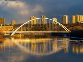 The Walterdale Bridge is reflected in the North Saskatchewan River as the sun sets on Wednesday, April 12, 2023 in Edmonton.