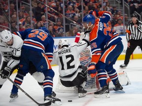 Goalie Stuart Skinner (74), Leon Draisaitl (29) and Darnell Nurse (25) of the Edmonton Oilers, keep Trevor Moore of the Los Angles Kings away from the loose puck at Rogers Place in Edmonton on March 30. The high-scoring Oilers have flipped the switch to playoff-style tight defensive hockey, allowing a total of two goals in their past four games.