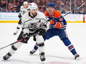 Connor McDavid (97) of the Edmonton Oilers, chases Drew Doughty of the Los Angeles Kings into the corner at Rogers Place in Edmonton on April 19, 2023.