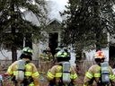 Firefighters work at a house fire near 108 Avenue and 107 Street in Edmonton, Tuesday April 4, 2023. Photo by David Bloom