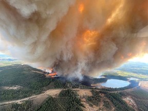 FILE PHOTO: A smoke column rises from wildfire EWF031 near Lodgepole, Alberta on May 4, 2023.