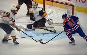 The puck deflects off a stick, almost in, then Evander Kane is a moment late to slam home the rebound
