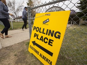 People enter a polling station at Meadowlark Christian School in the Edmonton-Meadowlark constituency in Edmonton on May 5, 2015, during Alberta's provincial election.