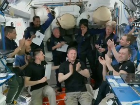 An image from a NASA video shows 11 astronauts aboard the International Space Station. Six more were on China's Tiangong station.