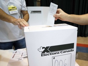 A person casts their vote in the 2021 federal election at a polling station in Winnipeg, September 20, 2021.