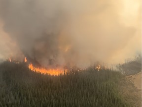 The east side of the Paskwa fire (HWF030) burns near Fox Lake on Tuesday, May 9, 2023.