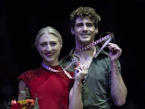 Canadian ice dance gold medallists Piper Gilles and Paul Poirier hold up their medals during victory ceremonies at Skate Canada International in Mississauga, Ont., on Saturday, October 29, 2022.