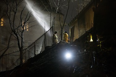 Firefighters work at the scene of a large brush fire below the Courtyard by Marriott Edmonton, Thursday, April 27, 2023.