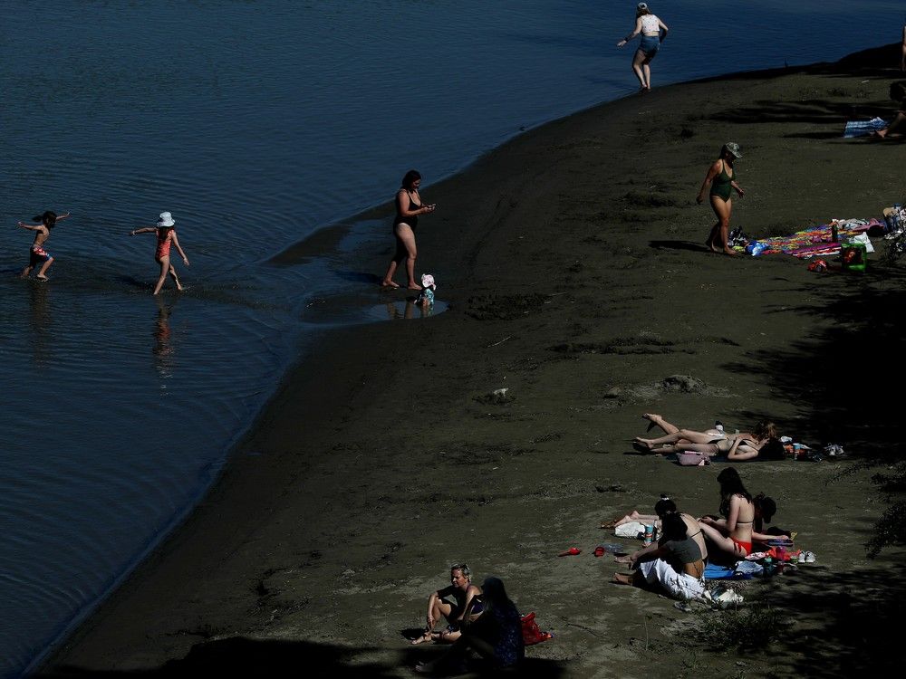 Edmontonians try to beat the heat at Accidental Beach along the North Saskatchewan River, in Edmonton Monday, May 15, 2023.
