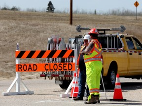 Traffic is directed around a road closure of westbound Highway 16 at Highway 31 due to wildfires west of Edmonton on Monday, May 1, 2023.