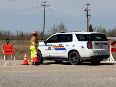 An RCMP vehicle heads through a road closure, due to wildfires, along Highway 16 at Highway 31, Monday, May 1, 2023.