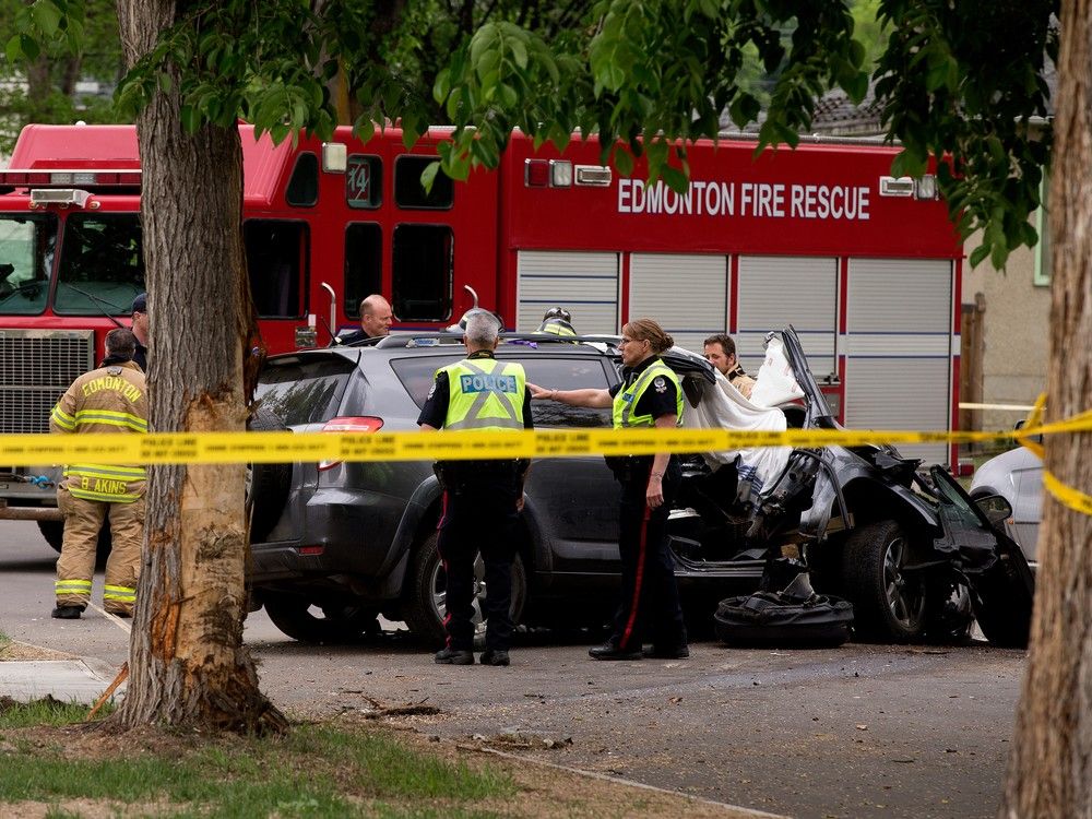 Police and fire crews work at the scene of a fatal collision along 120 Avenue at 89 Street in Edmonton on Thursday, May 25, 2023.