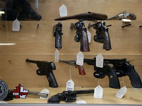 A selection of hand guns on display at an Ottawa store in June, 2022, shortly after Prime Minister Justin Trudeau announced a proposed freeze on sales in the wake of recent mass shootings in the U.S.