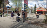 Two Muslim men were accosted and liquid poured on their brochures and pamphlets by an unknown man in black tank top, right, at their Islam information booth on Whyte Avenue and 107 Street on May 10, 2023.