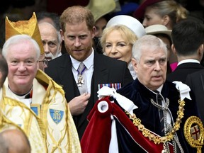 Britain's Prince Harry, Duke of Sussex, and Prince Andrew leave Westminster Abbey following the coronation ceremony of Britain's King Charles and Queen Camilla, in London, Saturday, May 6, 2023.