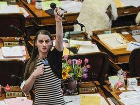 FILE - State Rep. Zooey Zephyr, D-Missoula, alone on the house floor stands in protest as demonstrators are arrested in the house gallery, Monday, April 24, 2023, in the Montana State Capitol in Helena, Mont.