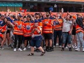 People celebrate the Oilers first goal at the watch party in the Ice District on Wednesday, May 3, 2023 .