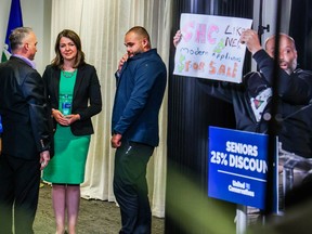 UCP Leader Danielle Smith waits as protesters disrupted a news conference in Calgary on Thursday, May 11, 2023.