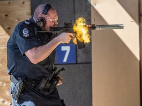 Const. Erik Tolley fires an AR-15 rifle on Thursday, May 4, 2023, that police consider a ghost gun because it has no serial number and has no manufacturer markings. Edmonton police displayed 11 seized firearms and demonstrated use of one of the weapons.