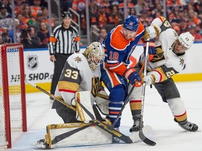 Zach Hyman (18) of the Edmonton Oilers, is sandwiched between Adin Hill and Alec Martinez of the Las Vegas Golden Knights in game six of the second round of the NHL playoffs at Rogers Place in Edmonton on May 14, 2023.