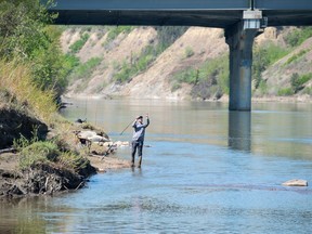 Fishermen cast their lines into the North Saskatchewan River on a sunny spring day in Edmonton on May 12, 2023.  Photo by Shaughn Butts-Postmedia