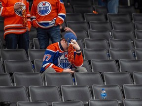 An Oilers fan stays in his seat after game six of the second round of the NHL playoffs at Rogers Place in Edmonton on May 14, 2023. The Golden Knights advanced in the playoffs after taking the series four games to two.