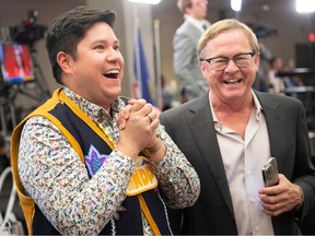 Brooks Arcand-Paul, left, reacts with David Eggen as he was declared the winner in the riding of Edmonton-West Henday at the Westin Hotel as the the Alberta election results were revealed on Monday, May 29, 2023.