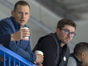 Jason Spezza (left) and Kyle Dubas watch practice when they were with the Toronto Maple Leafs.