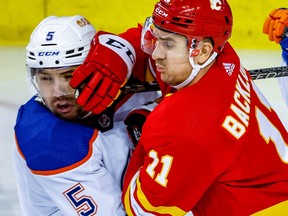 Edmonton Oilers' Cody Ceci battles against Mikael Backlund of the Calgary Flames during a game last season.