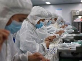 Workers produce medical supplies that will be exported at a factory in Binzhou, in China's eastern Shandong province on June 15, 2023.