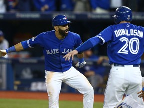 Jose Bautista celebrates with Josh Donaldson after hitting a three-run home run in the 7th inning giving the Jays a 6-3 win against the Texas Rangers in game five of the American League Division Series in Toronto, October 2015.