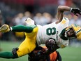 Edmonton Elks slotback Emmanuel Arceneaux (84) is hit by B.C. Lions defensive back T.J. Lee after making a reception in Vancouver on August 6, 2022.