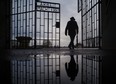 FILE - A man walks through the gate of the Sachsenhausen Nazi death camp with the phrase 'Arbeit macht frei' (work sets you free) at the International Holocaust Remembrance Day, in Oranienburg, about 30 kilometers, (18 miles) north of Berlin, Germany, Jan. 27, 2019.