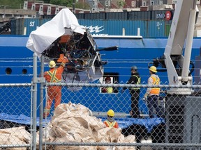 Debris from the Titan submersible, recovered from the ocean floor near the wreck of the Titanic, is unloaded from the ship Horizon Arctic at the Canadian Coast Guard pier in St. John's on Wednesday, June 28, 2023.