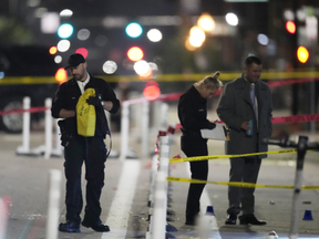 Denver Police Department investigators work the scene of a mass shooting along Market Street between 20th and 21st avenues during a celebration after the Denver Nuggets won the team's first NBA Championship early Tuesday, June 13, 2023, in Denver.
