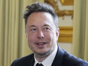 FILE - Twitter, now X. Corp, and Tesla CEO Elon Musk poses prior to his talks with French President Emmanuel Macron, May 15, 2023 at the Elysee Palace in Paris. Lawyers seeking to bring a class-action lawsuit against Tesla submitted declarations Monday, June 5, 2023, in Alameda County Superior Court from 240 Black workers who testified to rampant racism and discrimination at the electric car maker's Fremont factory in Northern California.