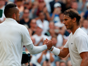 Spain's Rafael Nadal (R) shakes hands with Australia's Nick Kyrgios (L) after Nadal won their men's singles second round match on the fourth day of the 2019 Wimbledon Championships at The All England Lawn Tennis Club in Wimbledon, southwest London, on July 4, 2019.