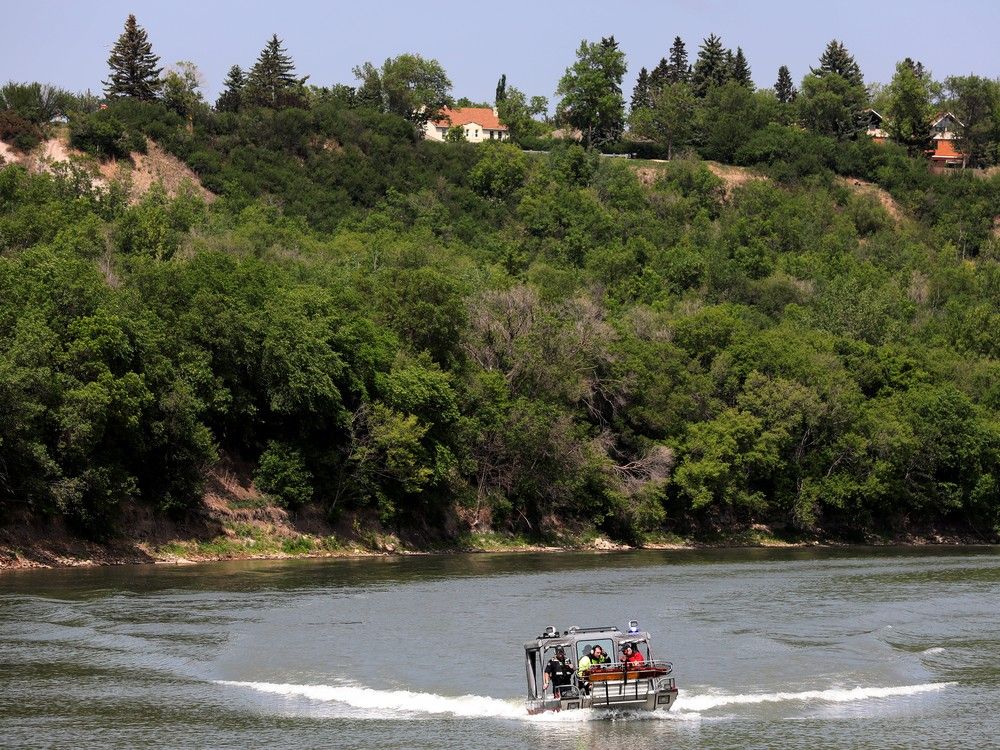 Edmonton Fire Rescue brings a woman ashore after responding to a call about a person in the North Saskatchewan River near the Dawson Bridge, Monday June 5, 2023. 
