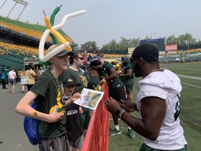 Edmonton Elks running back Kevin Brown signs autographs during Fan Appreciation Day at Commonwealth Stadium on Saturday, June 10, 2023.