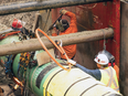 Construction crew works on pipe during construction on the Trans Mountain Pipleline expansion project at Bridal Falls, between Hope and Chilliack in the Fraser Valley.