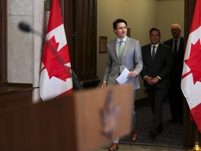 Prime Minister Justin Trudeau, Minister of Public Safety Marco Mendicino (centre) and Minister of Emergency Preparedness Bill Blair arrive to hold a press conference on Parliament Hill in Ottawa on Tuesday, May 23, 2023.