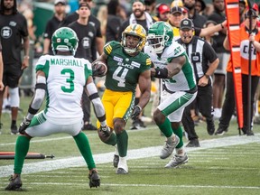 Running back Kevin Brown of the Edmonton Elks avoids a tackle from Albert Awachie of the Saskatchewan roughriders in the first half of the Edmonton Elks home opener at Commonwealth Stadium against the Saskatchewan Roughriders on Sunday, June 11, 2023.