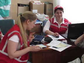 Nataliia Solovei, left, a Ukrainian nurse, and medical student Alina Manko provide assistance to a displaced woman from central Ukraine at a mobile clinic funded by the Canadian Red Cross, in Korsun-Shevchenkivskyi, Ukraine, Thursday, June 15, 2023.