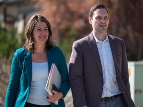 Alberta Premier Danielle Smith is accompanied by UCP MLA Matt Jones as she walks to a press conference to call the beginning of the 2023 provincial election on May 1.