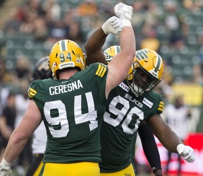 The Edmonton Elks' Kony Ealy (90) and Jake Ceresna (94) celebrate a quarterback sack against the Hamilton Tiger-Cats during first half CFL action at Commonwealth Stadium, in Edmonton Thursday July 13, 2023.