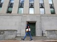 A pedestrian walks past the Bank of Canada building in Ottawa.