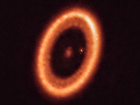 PDS 70 system, located nearly 400 light-years away and still in the process of being formed. Astronomers found evidence of two planets sharing the same orbit in the system.