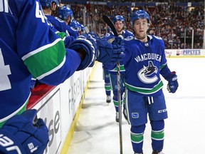 Brendan Leipsic of the Vancouver Canucks is congratulated by teammates after scoring during their NHL game against the New York Islanders at Rogers Arena March 5, 2018 in Vancouver.